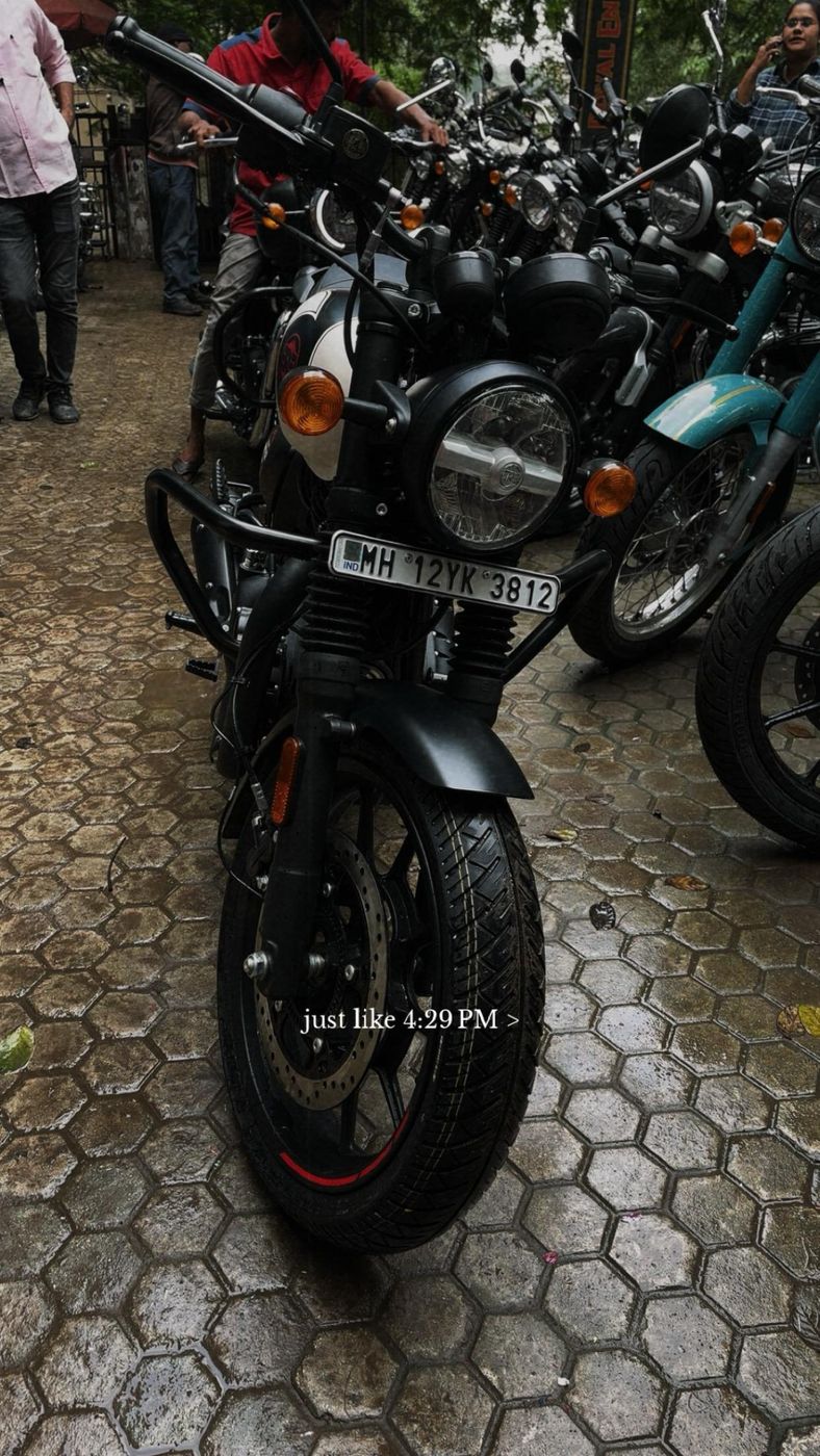 A motorbike parked on a cobbled path