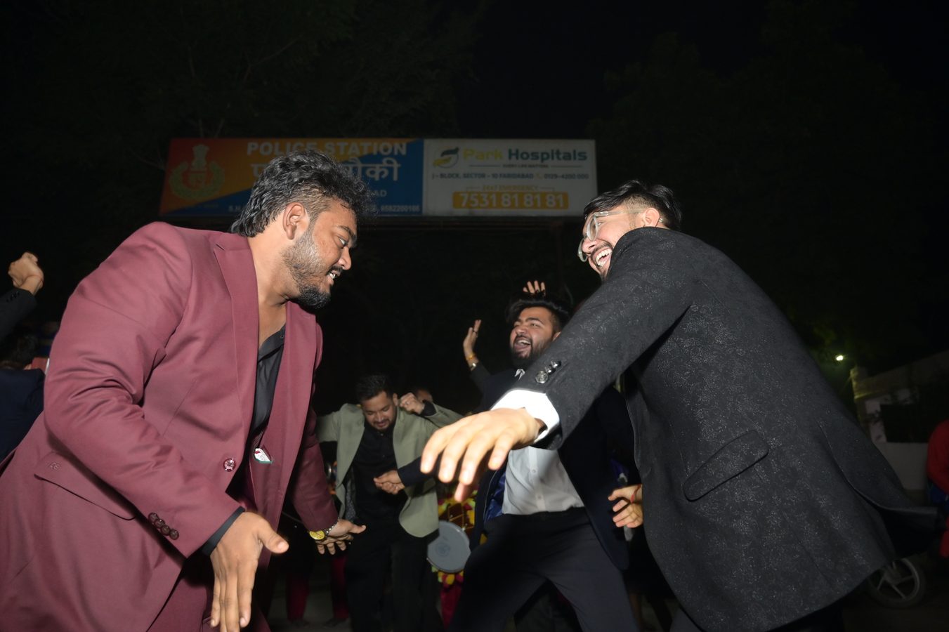 Jai dancing with friends at a night celebration
